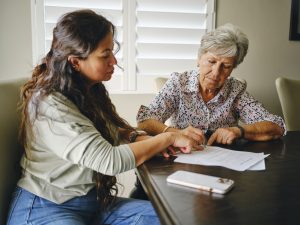 Woman Helping a Senior Wtih Documents